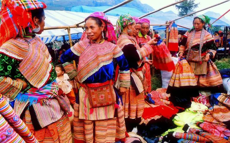 Vietnamese women in ethnic dresses in the market