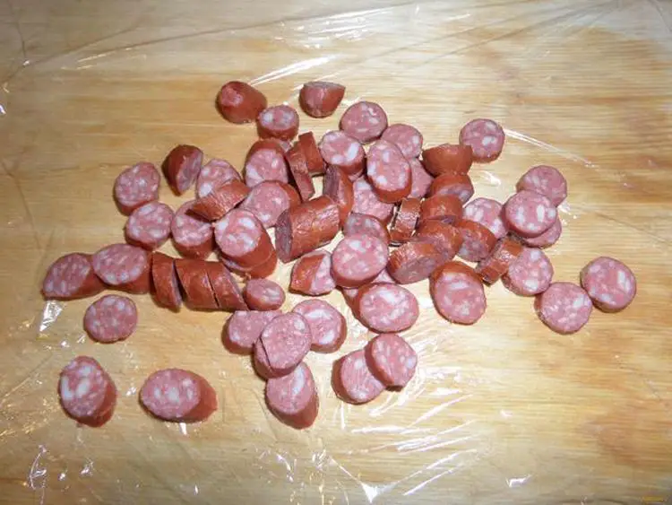Add slices of smoked sausage